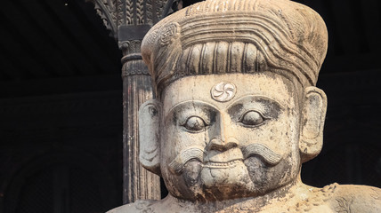 Fototapeta na wymiar Huge stone statue of wrestlers in front of a temple