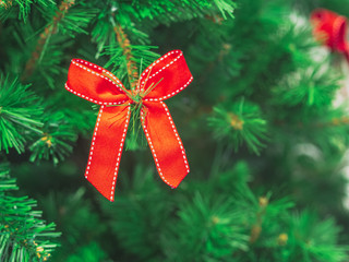 Closeup Soft focus red ribbon decorate on christmas tree. ChristmasDay Background.