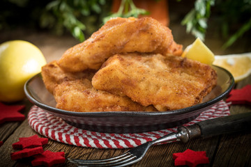 Fried cod slices in breadcrumbs.