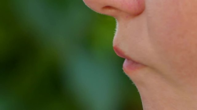 woman eats nuts, almonds, closeup