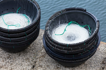 Two baskets with fishing line in a fishing port