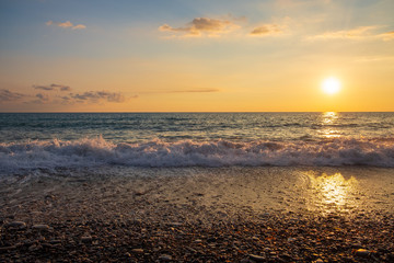 Beautiful sunset view of breaking waves at Petra tou Romiou (Aphrodite's birthplace) beach, in...