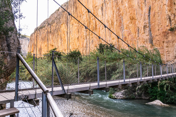Suspension bridge across River Turia on Ruta De Los Calderones (Puentes Colgantes) hiking trail near Chulilla, Valencia, Spain