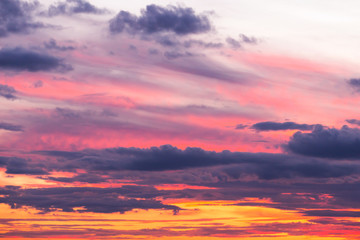 Beautiful soft dramatic sunset orange pink sky with clouds background