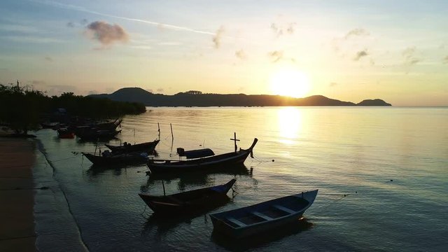 Longtail fishing boats in sea sunrise or sunset evening time