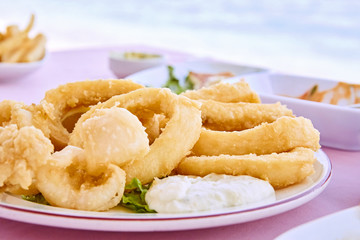 fried calamari, fried squid with lemon traditional greek cyprus food