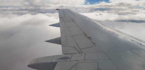 Fototapeta na wymiar Plane wing and clouds