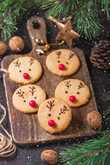 Homemade deer cookies decorated chocolate and red candies Soft focus Greeting card