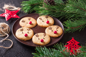 Homemade deer cookies decorated chocolate and red candies Soft focus Greeting card