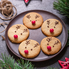 Homemade deer cookies decorated chocolate and red candies Soft focus Greeting card