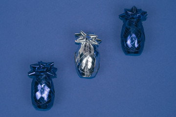 Shining blue and silver Christmas ornament on blue background.