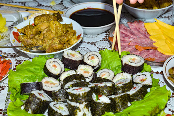 Rolls, sushi, Asian food and Japanese cuisine, chopsticks, festive food at the family table.