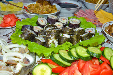 Rolls, sushi, Asian food and Japanese cuisine, chopsticks, festive food at the family table.