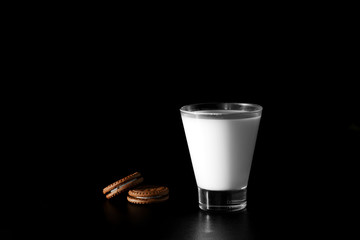 Glass of milk and chocolate cookies on black background - Powered by Adobe
