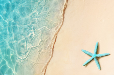 Fototapeta na wymiar Starfish on the summer beach. Summer background. Tropical sand beach