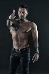 Man brutal unshaven hispanic appearance tattooed arms. Brutal strict macho with tattoos....