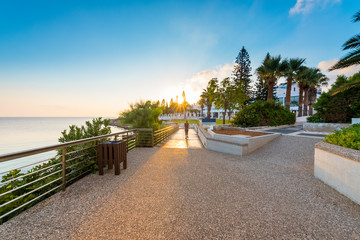 healthy lifestyle sports woman running on wooden boardwalk sunrise seaside