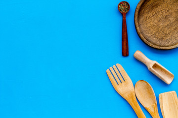 Village wooden cutlery set blue table background top view mockup