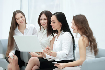 group of employees using laptop to check financial data