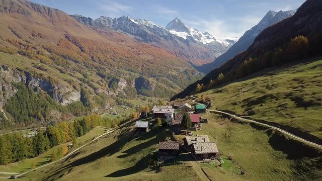 Rural Swiss Alps village with wooden barns