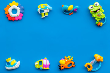 Handmade toys for newborn baby. Rattle. Blue background top view mockup