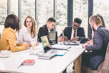Happy working business team in modern office