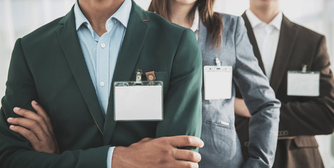 closeup.group of business people with blank badges - obrazy, fototapety, plakaty
