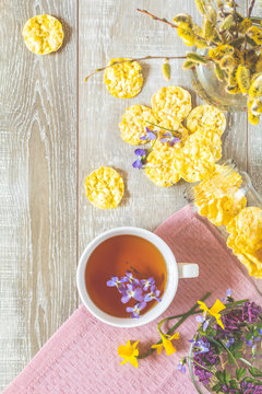 Cup of tea with violet viola, delicious nutritious cereal breads