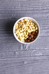 Assortment of nuts on a dark wooden table. View from above