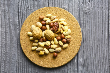 Assortment of nuts on a dark wooden table. View from above