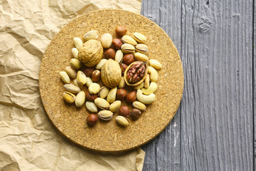 Assortment of nuts on a dark wooden table. View from above