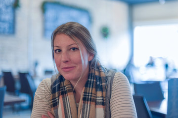 Candid portrait of young woman sitting at a restaurant