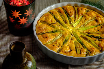 Delicious quiche made with eggs and asparagus, in baking form
