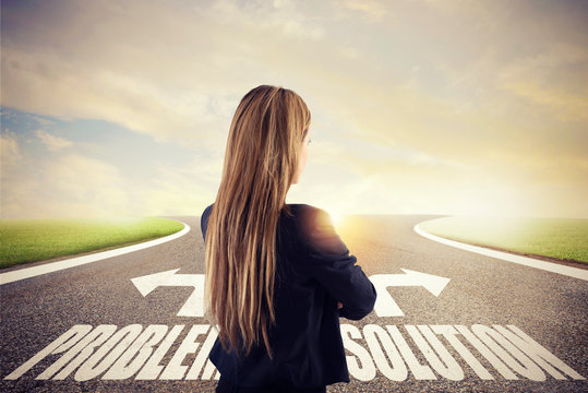 Businesswoman at a crossroads. She chooses the correct way. Concept of decision in business