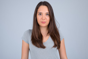 Obraz premium Young beautiful multi-ethnic woman against white background