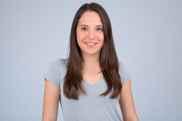Obraz premium Young happy multi-ethnic woman smiling against white background
