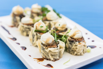White plate with some hot roll with cream cheese