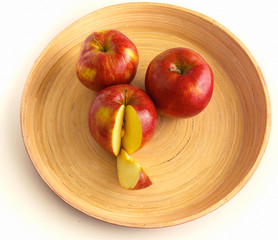 Fototapeta na wymiar wooden plate with ripe fresh red apples