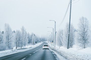 Car on a road in a snowy winter Lapland