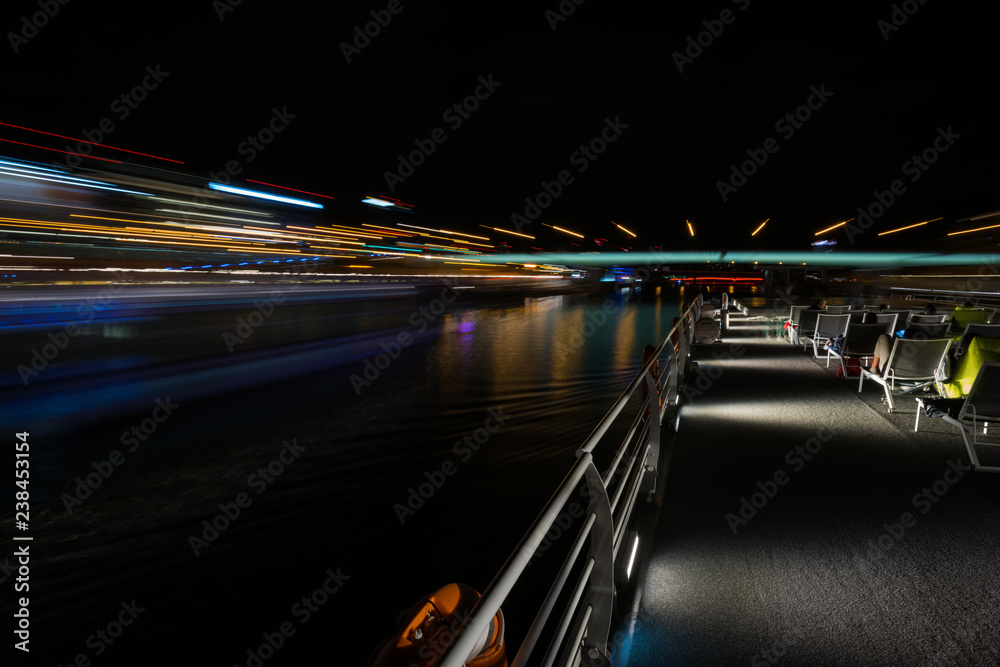 Wall mural Walking around Paris on a boat on the Seine River in the night