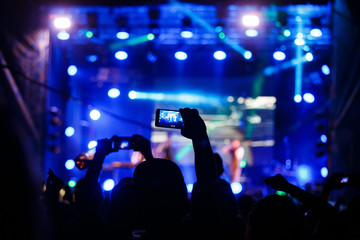 People at concert shooting video or photo.