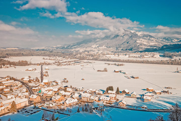 Landscape with Alpine Mountains and Gruyeres town village in winter