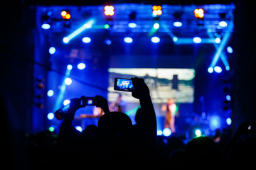 Fototapeta na wymiar People at concert shooting video or photo.