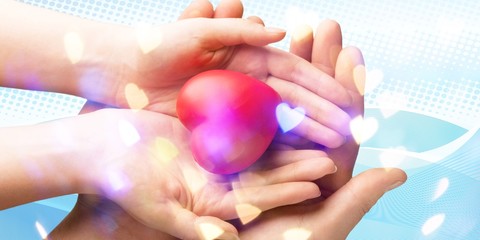 Man and woman holding red heart