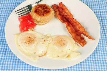 Eggs Over Easy Butter Biscuit Jelly and Bacon
