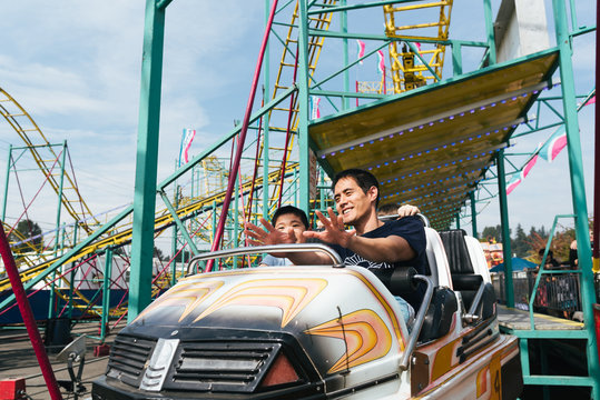 Father and son on an amusement park ride