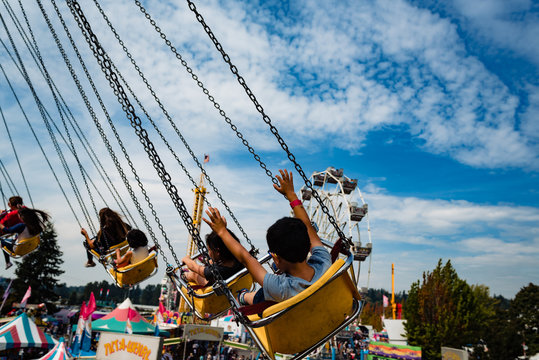 Children on a merry go round ride