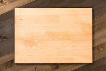 Empty cutting board isolated on wooden surface