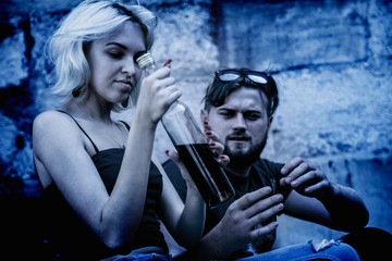 Deviant behavior and social isolation concept. Drunk young people as symbol of pain, hopelessness...