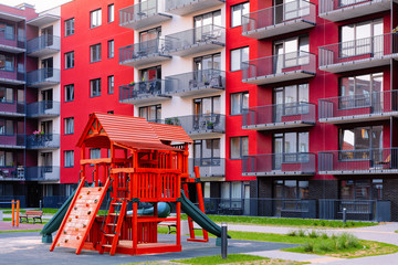 Fototapeta na wymiar Children playground at Modern residential apartment house complex outdoor facility